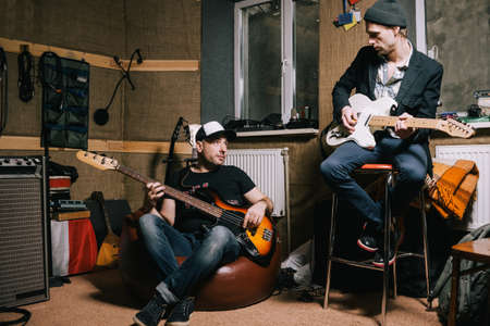 Band of adult guitarists rehearsing in garage. Grown-up musicians, creative hobby for hipsters, music repetitionの写真素材