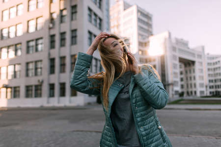 Passerby talk on phone in city. Modern communication, social media technologyの写真素材