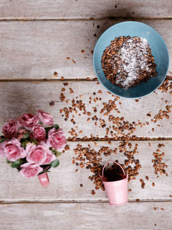 Healthy cereal breakfast on wooden background. Sweet granola in teal bowl. Wholegrain vegetarian morning tasty meal. Food photography top viewの写真素材