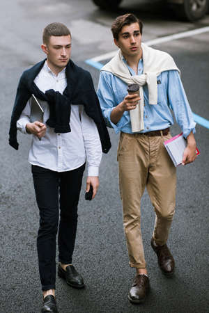 Fashionable pedestrians on street. Stylish men, modern youth lifestyle, communication conceptの写真素材