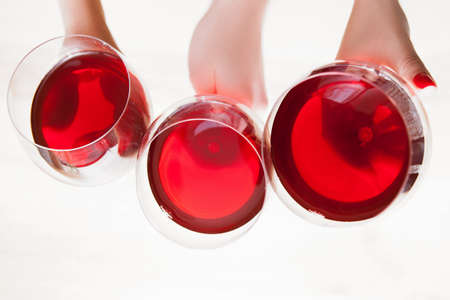 Red wine advertising on white background. Tasty alcoholic drinks top view, exquisite beverages in glass closeup, commercial conceptの写真素材