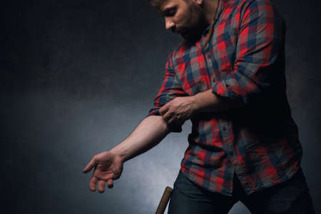 Male adult worker on dark background. Guy working with his hands, man strength closeup with free...