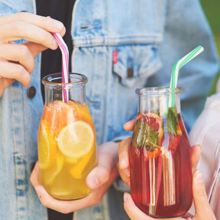 Healthy nutrition. Friends drinking fresh juice detox tea. Youth lifestyle, vegetarian diet to go, fitness food, weight loss conceptの写真素材