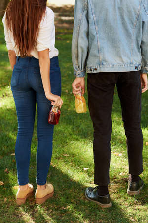 Healthy nutrition. Friends drinking fresh juice detox tea back view. Youth lifestyle, vegetarian diet to go, fitness food, weight loss conceptの写真素材