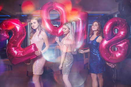 Beautiful stylish girls at New Year party. Merry Christmas 2018 in night club, festive mood background. Friends celebrating together, beauty conceptの写真素材