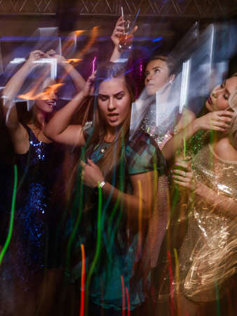 Active girl in night club in blurred motion. Stylish lady at Christmas discotheque, New Year...