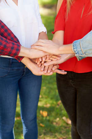 Student teamwork. Closeup of man amd woman hans together stack. Friendship forever, togetherness,...