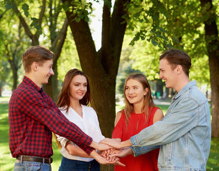 Student teamwork. Closeup of man amd woman hans together stack. Friendship forever, togetherness, youth team conceptの写真素材