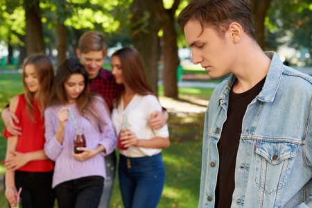 Jealousy and envy in friends relationship. One macho man dating with all women on the party. Seduction secrets, pickup, alpha male conceptの写真素材