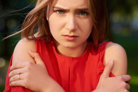 Loneliness. Offended and sad girl. Lack of communication, quarrel, break of relations, divorce, need help, cold weather conceptの写真素材