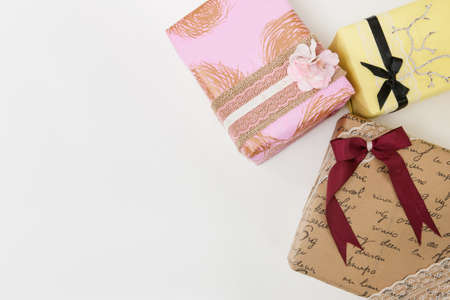 Top view festive wrapped presents on white background with free space on left. Congratulations,...