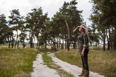 Photographer woman camera staring afar concept. Working process. Unity with nature.