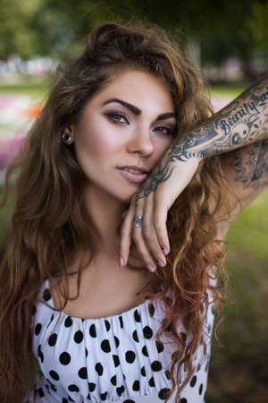 Confidence in life. Modern female beauty closeup. Urban youth style, beautiful woman portrait. Confident and stylish girl with tattoo, fashion conceptの写真素材