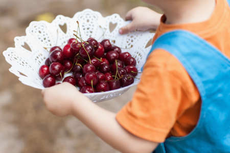 Healthy treats nature berries child concept. Advertisement of proper nutrition. Happy childhood.の写真素材