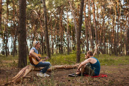 Friends picnic guitar music nature concept. Traveler lifestyle. Hiking happy moments.の写真素材