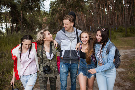 Young friends group forest tourism concept. Adventure trip by the wood. Happy together.の写真素材