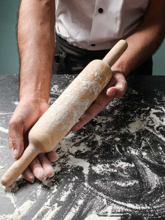Food pastry. Chef cooking at restaurant. Baker roll dough with kitchen utensil