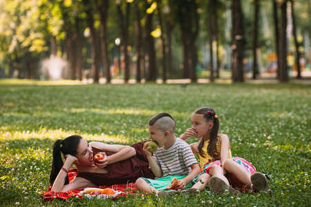 Family fruit snack picnic nature concept. Happy together. Active lifestyle.の写真素材