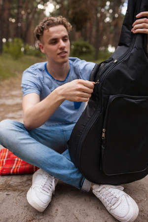 Guitar player man life nature stroller concept. Active lifestyle. Unity with the nature.の写真素材