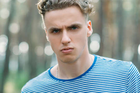 Dissatisfied handsome hiker man nature concept. Traveler lifestyle. Unpleasant newsの写真素材