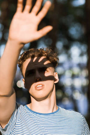 Dazzled sunlight handsome man nature concept. Traveler lifestyle. Alone with problems. Blind path.の写真素材