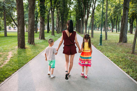 Happy family walk park nature concept. Delights of motherhood.の写真素材