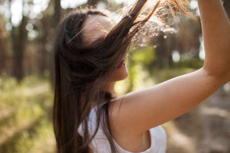 Pretty sunny stranger woman forest happiness concept. Unity with nature.の写真素材