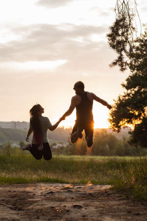 Romance couple jump together nature concept. Traveler leisure. Active lifestyle.の写真素材