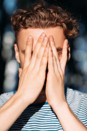 Upset handsome hiker man nature concept. Traveler lifestyle. Alone with problems.の写真素材