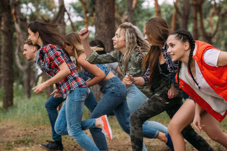 Friends group running competition concept. Rivalry spirit, tourist leisure on nature.の写真素材