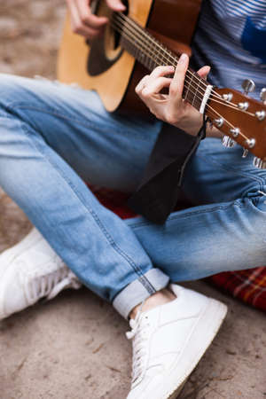 Music lifestyle man playing guitar concept. Stroller man at the nature. Artist instruments advertisement.の写真素材