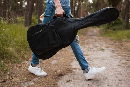 Guitar player man life nature stroller concept. Active lifestyle. Unity with the nature.