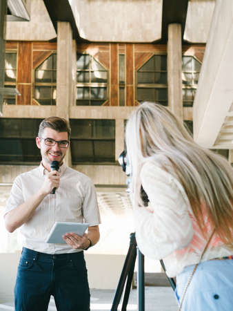 anchorman and operator filming news coverage story. journalism mass media tv broadcast conceptの写真素材