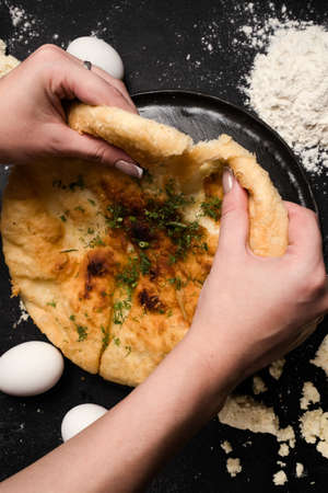 nourishing imeretian khachapuri tasting. fatty delicious unhealthy food. georgian cuisineの写真素材