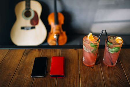romantic date of two music lovers. spend some quality time at a bar with refreshing beverages. modern phone technology conceptの写真素材