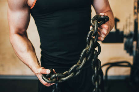 Strong man gym sport bodybuilder concept. Break the shackles of laziness. Athlete lifestyle.の写真素材