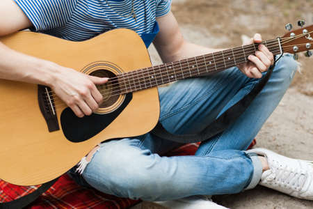 Music lifestyle man playing guitar nature concept. Stroller man. Artist instruments advertisement.