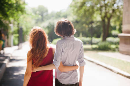 Teenage date in a park. Romance flirting and young love conceptの写真素材