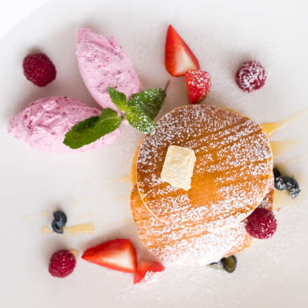 fancy restaurant breakfast dessert. Sweet fruit pancakes on white background. Haute cuisine conceptの写真素材