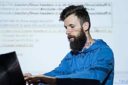 Teacher looks at laptop while lecturing at seo courses. Business optimization, content analysis and...