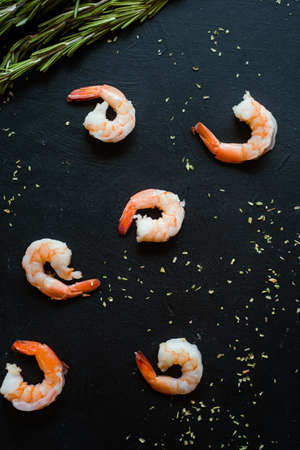 Abstract seafood shrimps on dark background. Good source of omega 3 acid unsaturated fats.の写真素材