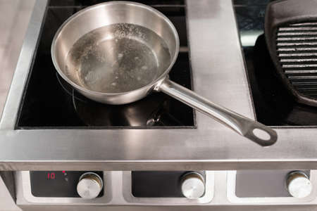 Pot and other kitchen utensils in professional restaurant. Chefs little helpersの写真素材