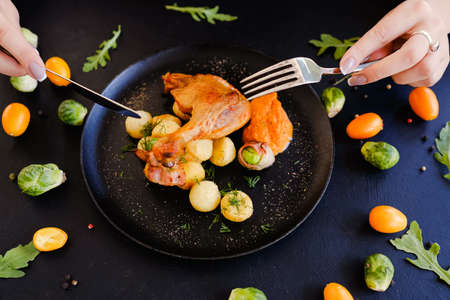 tasting ready made chicken leg dish breakfast concept. delicious and hearty food. restaurant delicacy.の写真素材