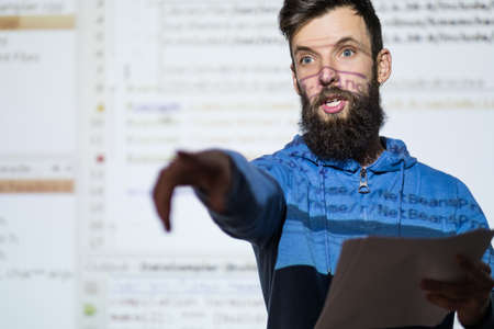 Elocution or speech craft courses. Bearded young male orator interacts with someone in the audience pointing a finger. Dialogue, discussion and rhetoric basics conceptの写真素材