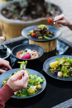 friends dinner at a restaurant. Eating brunch together. Leisure and pastime concept. Modern...