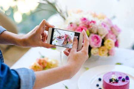 woman blogger smartphone photo party pastries concept. creation process. dependency of social...