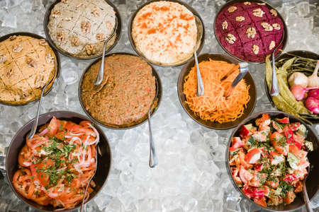 western asia cuisine. Selection of freshly made meals on ice. Restaurant kitchen hacks