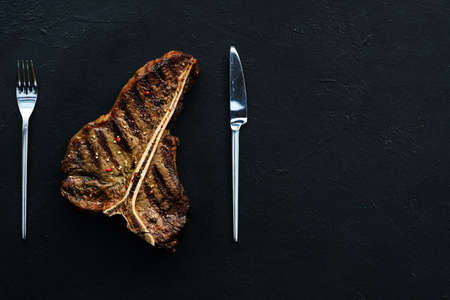 T bone steak on dark background. Grilled mexican style meat. Juicy tender pork chop. Simple tasty mealの写真素材