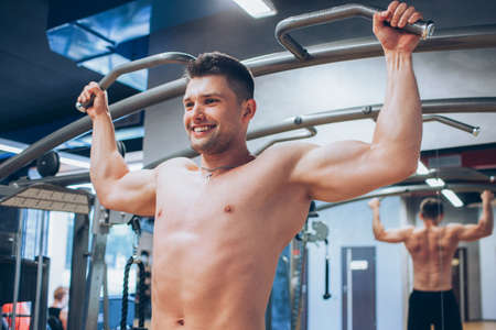 Pull-ups hard training gym man sport concept. Lifestyle of athlete. Strength of will.