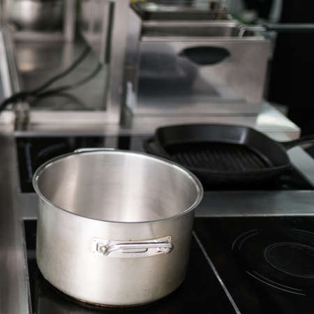 Saucepan and other kitchen utensils in professional restaurant. Chefs little helpers